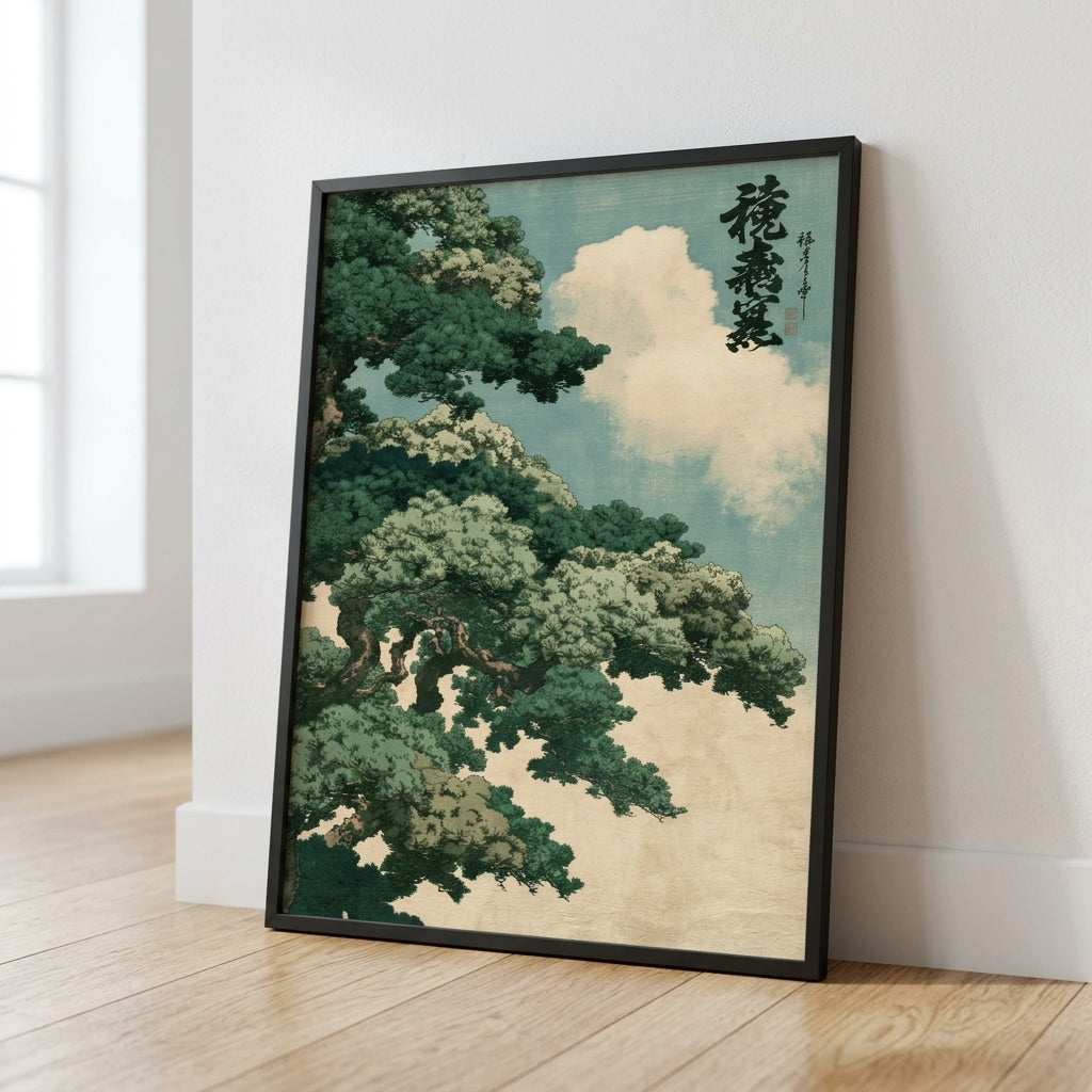 A framed art print featuring a Japanese-style tree with green foliage and white clouds against a pale blue sky, leaning against a white wall on a light wood floor.