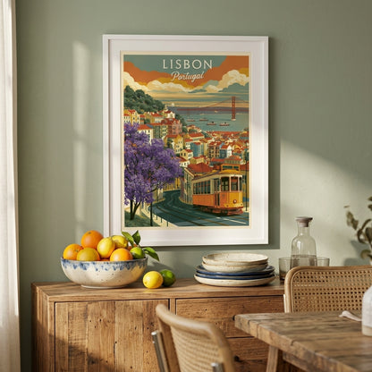 A framed vintage-style Lisbon travel poster hangs on a sage green wall above a wooden sideboard in a dining room. The poster depicts a yellow tram, purple flowers, and the Eiffel Tower over water, with the words 'LISBON Portugal' at the top.