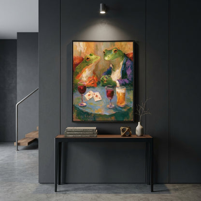 A framed colorful painting of two green frogs sitting at a table with drinks and playing cards, displayed on a dark gray paneled wall above a console table in a modern interior setting.