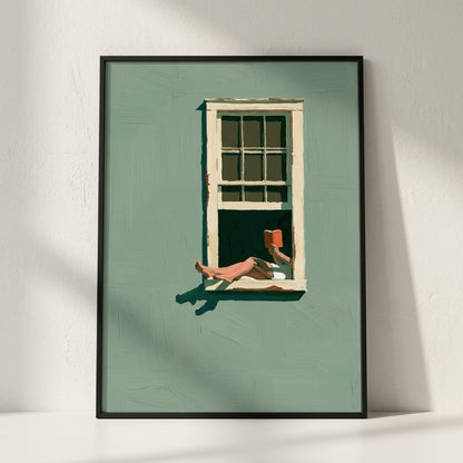 A framed art print leaning against a white wall. The print features a stylized illustration of a person's legs and hand holding an orange book, resting by an open window on a sage green background.